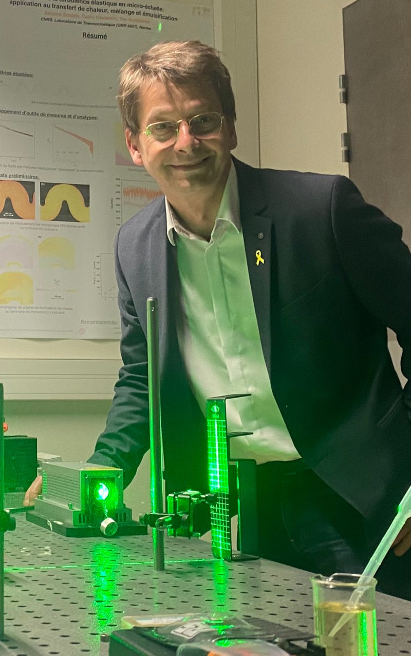 Teo Burghelea in the laboratory next to a laser optical set-up